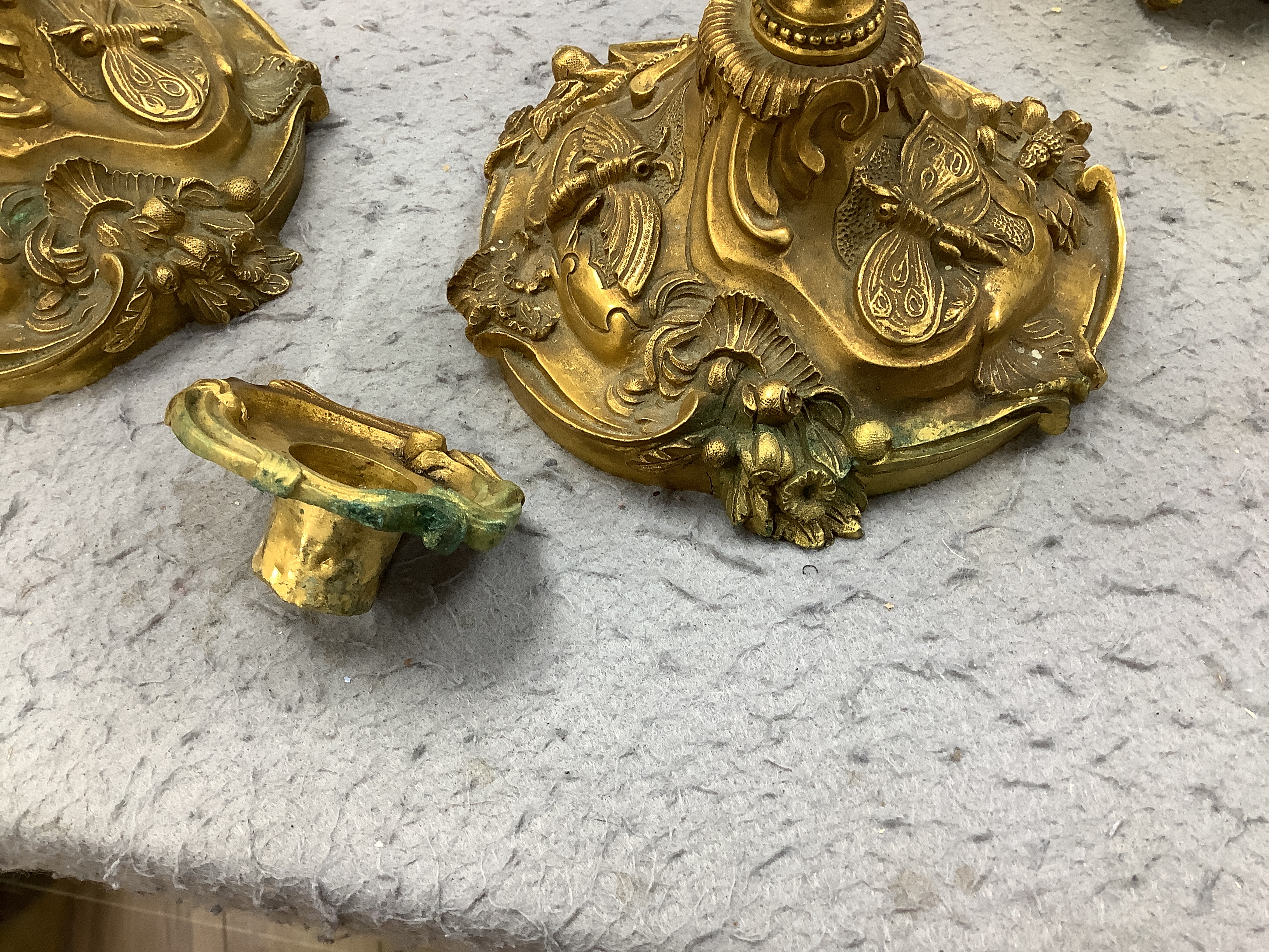 A pair of French ormolu candlesticks, one detached sconce, 30cm